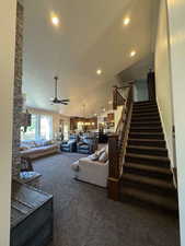 Living area with stairs, carpet flooring, ceiling fan, and recessed lighting