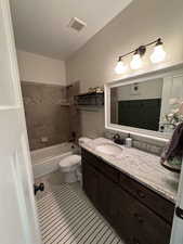 Bathroom featuring vanity, toilet, tile patterned flooring, and shower / bathtub combination