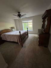 Bedroom with carpet flooring, baseboards, and ceiling fan