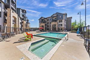 Community pool with a patio