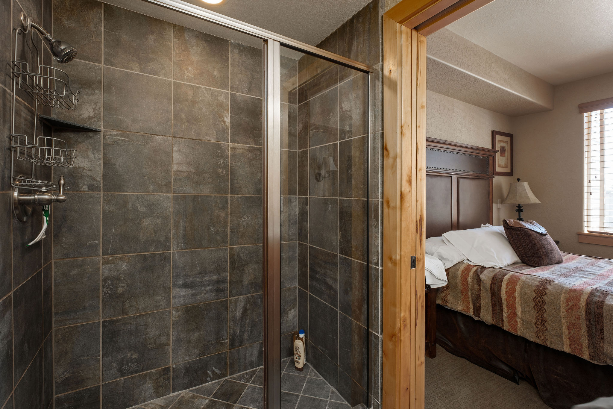 Ensuite bathroom featuring a stall shower