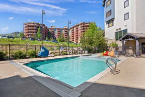 Community pool featuring a patio
