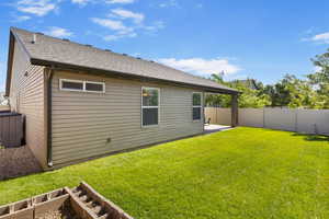 Back of property featuring a patio area and roof with shingles
