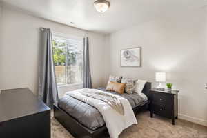 Carpeted bedroom featuring baseboards