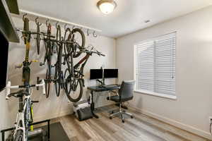 Office with wood finished floors and baseboards