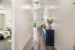 Corridor with wood finished floors and baseboards