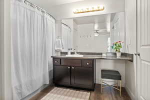 Bathroom featuring wood finished floors, vanity, and ceiling fan