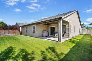 Rear view of property featuring a patio area and a gate