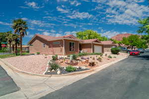 Single story home featuring a tile roof, a garage, and stucco siding