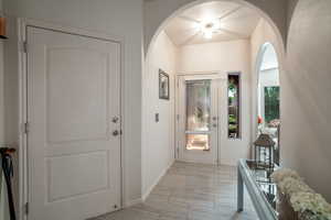 Foyer featuring baseboards and arched walkways
