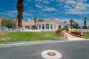 View of front of property with a tile roof and stucco siding