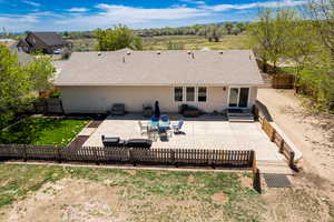 Back of property featuring a patio area and roof with shingles