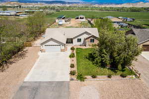Aerial view of property and surrounding area featuring a mountain backdrop