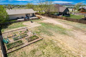 View of yard featuring a vegetable garden and a deck with mountain view