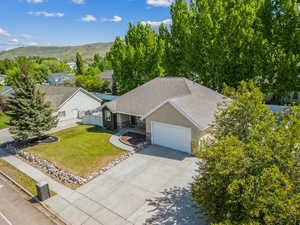Aerial view of property and surrounding area with a mountain backdrop
