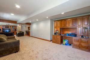 Carpeted living area with recessed lighting, a desk, and beam ceiling