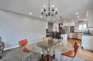Dining space featuring a chandelier, recessed lighting, light wood-style flooring, and baseboards
