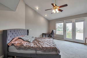 Bedroom with access to outside, carpet, vaulted ceiling, baseboards, and a ceiling fan