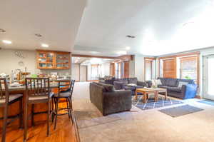 Carpeted living room featuring recessed lighting