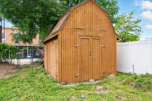 View of shed featuring a fenced backyard