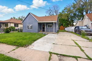 Bungalow-style house with a porch, driveway, and roof with shingles