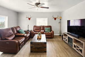 Living room with wood finished floors and ceiling fan