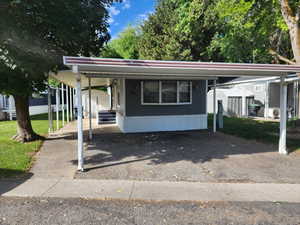 Manufactured / mobile home featuring driveway and a carport