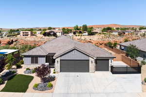 Ranch-style home featuring board and batten siding, a garage, concrete driveway, stone siding, and a mountain view