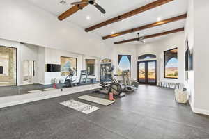 Exercise area featuring ceiling fan, baseboards, a high ceiling, recessed lighting, and french doors