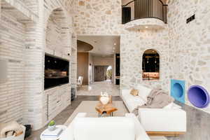 Living room featuring a towering ceiling and wood finished floors