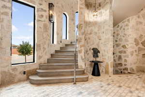 Stairs featuring brick patterned flooring