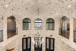 Detailed view of arched walkways, a chandelier, and recessed lighting