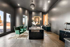 Interior space featuring two vanities, recessed lighting, french doors, and concrete floors