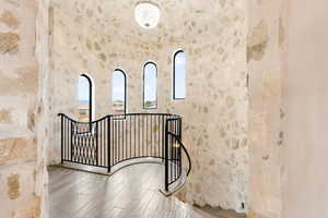 Stairs featuring wood finished floors