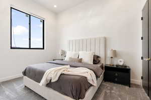 Carpeted bedroom featuring baseboards and recessed lighting
