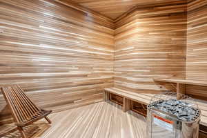 Relaxing sauna featuring wooden walls