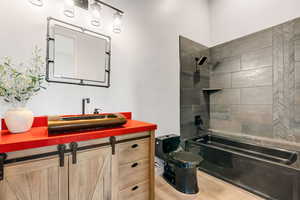 Bathroom featuring toilet, bathtub / shower combination, and vanity