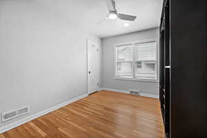 Unfurnished room featuring baseboards, a ceiling fan, and light wood-style floors