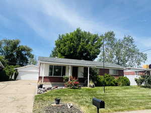 Ranch-style home featuring brick siding, and a detached garage