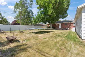 View of yard with a trampoline