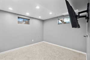 Basement featuring carpet floors, recessed lighting, and baseboards