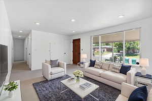 Living area with recessed lighting and baseboards