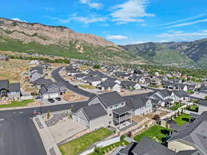 Aerial view of property's location featuring nearby suburban area and a mountain backdrop