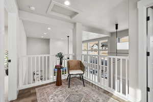 Living area with recessed lighting and dark wood-style floors