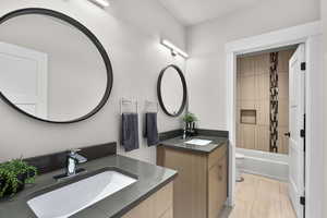 Bathroom with two vanities and shower / bath combo