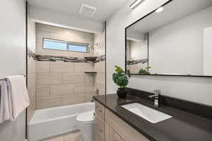 Full bathroom featuring vanity and washtub / shower combination