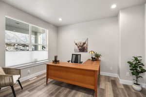 Office featuring wood finished floors, recessed lighting, and a textured ceiling
