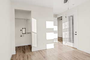 Unfurnished bedroom featuring light wood finished floors and baseboards