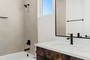 Bathroom featuring vanity and bathtub / shower combination