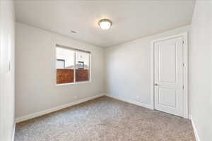 Spare room with carpet flooring and baseboards